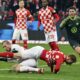 Mainz goalkeeper Robin Zentner drops his teammate Sepp van den Berg during the Bundesliga soccer match between VfL Wolfsburg and FSV Mainz at MEWA Arena stadium in Mainz, Germany, Saturday Jan. 13, 2024. (Torsten Silz/dpa via AP)