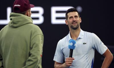 Novak Djokovic, right, of Serbia is interviewed by Nick Kyrgios following his win over Taylor Fritz of the U.S. in their quarterfinal match at the Australian Open tennis championships at Melbourne Park, Melbourne, Australia, Tuesday, Jan. 23, 2024. (AP Photo/Asanka Brendon Ratnayake)
