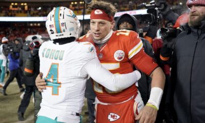 Miami Dolphins cornerback Kader Kohou (4) hugs Kansas City Chiefs quarterback Patrick Mahomes after an NFL wild-card playoff football game Saturday, Jan. 13, 2024, in Kansas City, Mo. (AP Photo/Charlie Riedel)