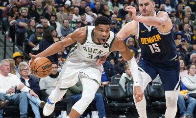 Milwaukee Bucks forward Giannis Antetokounmpo (34) drives past Denver Nuggets center Nikola Jokic (15) in the second half of an NBA basketball game Monday, Jan. 29, 2024, in Denver. (AP Photo/David Zalubowski)