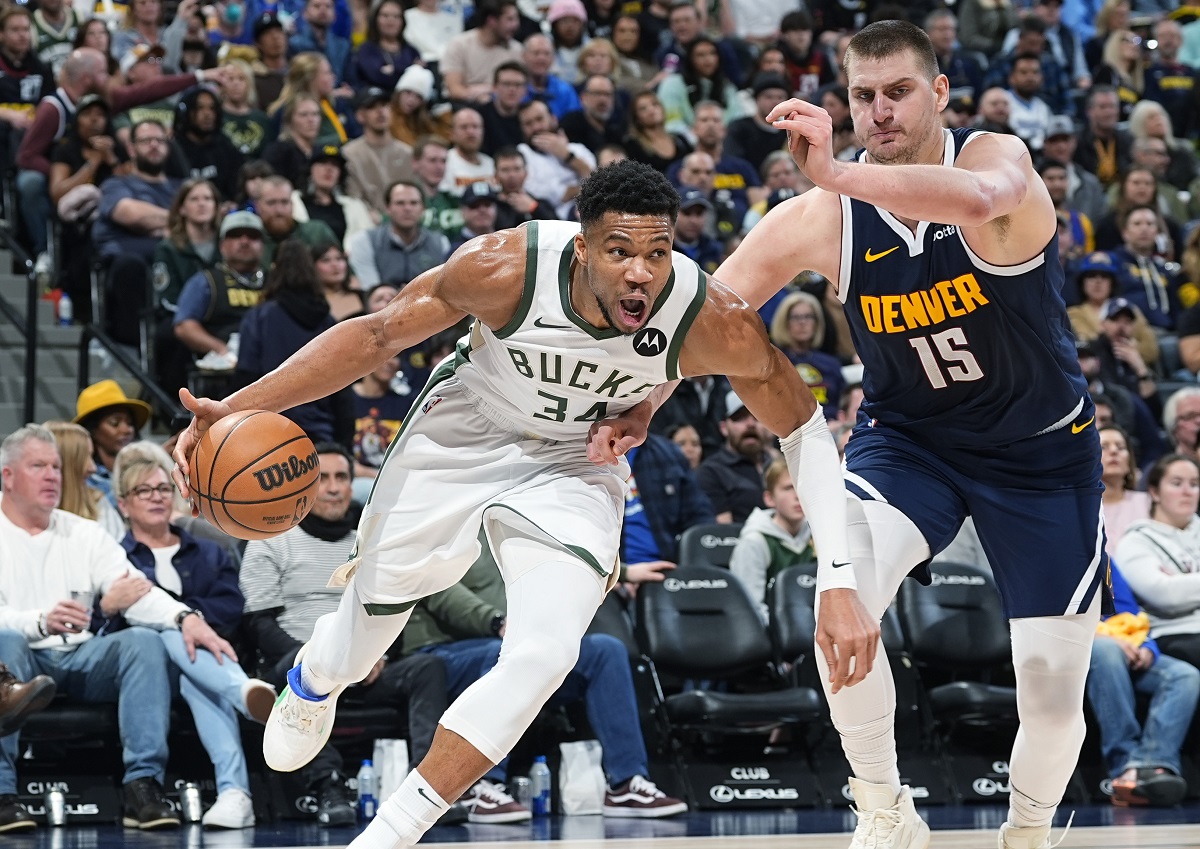 Milwaukee Bucks forward Giannis Antetokounmpo (34) drives past Denver Nuggets center Nikola Jokic (15) in the second half of an NBA basketball game Monday, Jan. 29, 2024, in Denver. (AP Photo/David Zalubowski)