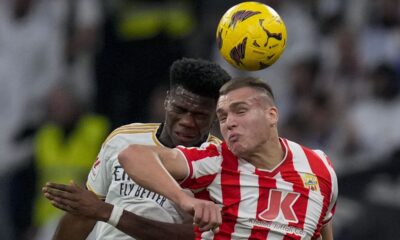 Almeria's Marko Milovanovic, right, jumps for the ball with Real Madrid's Aurelien Tchouameni during a Spanish La Liga soccer match between Real Madrid and Almeria at the Santiago Bernabeu stadium in Madrid, Spain, Sunday, Jan. 21, 2024. (AP Photo/Bernat Armangue )