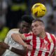 Almeria's Marko Milovanovic, right, jumps for the ball with Real Madrid's Aurelien Tchouameni during a Spanish La Liga soccer match between Real Madrid and Almeria at the Santiago Bernabeu stadium in Madrid, Spain, Sunday, Jan. 21, 2024. (AP Photo/Bernat Armangue )
