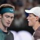 Jannik Sinner, right, of Italy and Andrey Rublev of Russia cross at a change of ends during their quarterfinal match at the Australian Open tennis championships at Melbourne Park, Melbourne, Australia, Wednesday, Jan. 24, 2024. (AP Photo/Alessandra Tarantino)