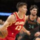Atlanta Hawks guard Bogdan Bogdanovic (13) dribbles past Washington Wizards forward Corey Kispert (24) during the second half of an NBA basketball game Saturday, Jan 13, 2024, in Atlanta. (AP Photo/Hakim Wright Sr.)