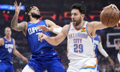 Oklahoma City Thunder guard Vasilije Micic, right, drives by Los Angeles Clippers guard Amir Coffey during the first half of an NBA basketball game Tuesday, Jan. 16, 2024, in Los Angeles. (AP Photo/Mark J. Terrill)