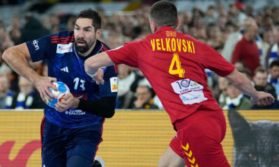 North Macedonia's Martin Velkovski, right, challenges France's Nikola Karabatic during the Men's European Handball Championship match between France and North Macedonia at the soccer stadium in Duesseldorf, Germany, Wednesday, Jan. 10, 2024. (AP Photo/Martin Meissner)