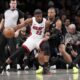 Miami Heat forward Jimmy Butler (22) drives against Brooklyn Nets guard Dennis Smith Jr., right, during the second half of an NBA basketball game, Monday, Jan. 15, 2024, in New York. (AP Photo/Mary Altaffer)