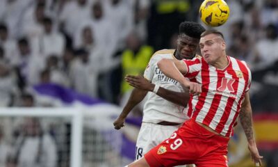Almeria's Marko Milovanovic, right, jumps for the ball with Real Madrid's Aurelien Tchouameni during a Spanish La Liga soccer match between Real Madrid and Almeria at the Santiago Bernabeu stadium in Madrid, Spain, Sunday, Jan. 21, 2024. (AP Photo/Bernat Armangue )