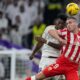 Almeria's Marko Milovanovic, right, jumps for the ball with Real Madrid's Aurelien Tchouameni during a Spanish La Liga soccer match between Real Madrid and Almeria at the Santiago Bernabeu stadium in Madrid, Spain, Sunday, Jan. 21, 2024. (AP Photo/Bernat Armangue )