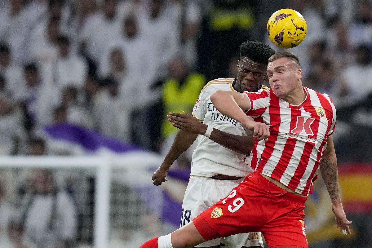 Almeria's Marko Milovanovic, right, jumps for the ball with Real Madrid's Aurelien Tchouameni during a Spanish La Liga soccer match between Real Madrid and Almeria at the Santiago Bernabeu stadium in Madrid, Spain, Sunday, Jan. 21, 2024. (AP Photo/Bernat Armangue )