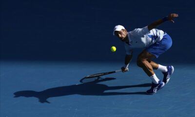 Novak Djokovic of Serbia plays a forehand return to Taylor Fritz of the U.S. during their quarterfinal match at the Australian Open tennis championships at Melbourne Park, Melbourne, Australia, Tuesday, Jan. 23, 2024. (AP Photo/Alessandra Tarantino)