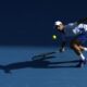 Novak Djokovic of Serbia plays a forehand return to Taylor Fritz of the U.S. during their quarterfinal match at the Australian Open tennis championships at Melbourne Park, Melbourne, Australia, Tuesday, Jan. 23, 2024. (AP Photo/Alessandra Tarantino)