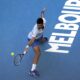 Novak Djokovic of Serbia plays a backhand return to Taylor Fritz of the U.S. during their quarterfinal match at the Australian Open tennis championships at Melbourne Park, Melbourne, Australia, Tuesday, Jan. 23, 2024. (AP Photo/Alessandra Tarantino)