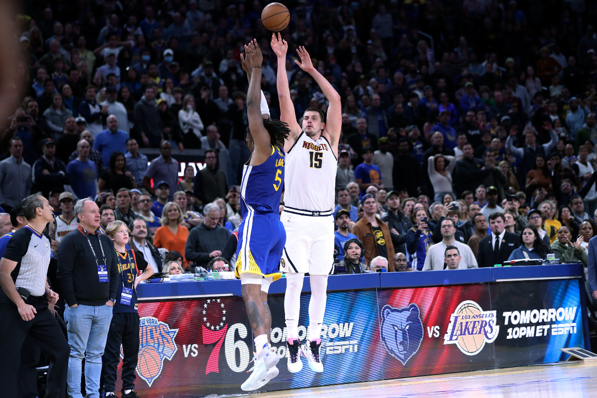 Denver Nuggets' Nikola Jokic hits a game-winning 3-pointer over Golden State Warriors' Kevon Looney during an NBA basketball game in San Francisco on Thursday, Jan. 4, 2024. (Scott Strazzante/San Francisco Chronicle via AP)
