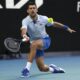 Novak Djokovic of Serbia plays a forehand return to Taylor Fritz of the U.S. during their quarterfinal match at the Australian Open tennis championships at Melbourne Park, Melbourne, Australia, Tuesday, Jan. 23, 2024. (AP Photo/Louise Delmotte)