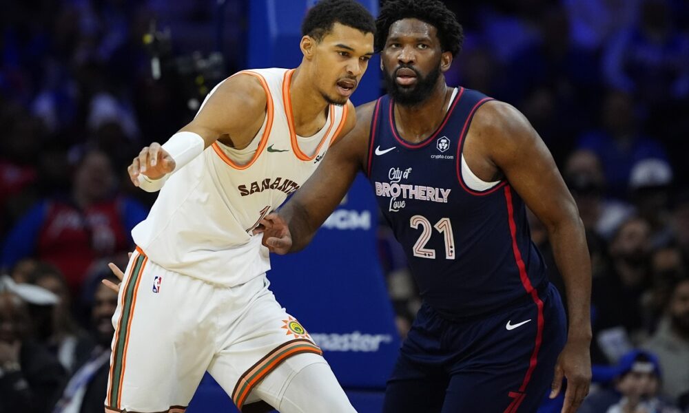 San Antonio Spurs' Victor Wembanyama, left, and Philadelphia 76ers' Joel Embiid struggle for position during the first half of an NBA basketball game, Monday, Jan. 22, 2024, in Philadelphia. (AP Photo/Matt Slocum)