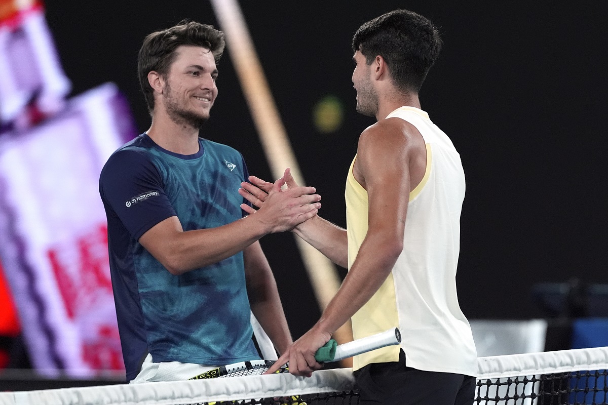 Carlos Alcaraz, right, of Spain is congratulated by Miomir Kecmanovic of Serbia following their fourth round match at the Australian Open tennis championships at Melbourne Park, Melbourne, Australia, Monday, Jan. 22, 2024. (AP Photo/Andy Wong)