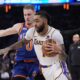 Los Angeles Lakers' D'Angelo Russell (1) drives past New York Knicks' Donte DiVincenzo (0) during the first half of an NBA basketball game Saturday, Feb. 3, 2024, in New York. (AP Photo/Frank Franklin II)