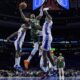 Milwaukee Bucks' Giannis Antetokounmpo (34) goes up for a shot against Philadelphia 76ers' Buddy Hield, left, and Paul Reed during the second half of an NBA basketball game, Sunday, Feb. 25, 2024, in Philadelphia. (AP Photo/Matt Rourke)