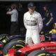 FILE - Mercedes driver Lewis Hamilton of Britain looks at Finnish driver Kimi Raikkonen's Ferrari after getting pole in the qualifying session for the Chinese Formula One Grand Prix at Shanghai International Circuit in Shanghai, China, Saturday, April 11, 2015. Seven-time Formula One champion Lewis Hamilton has been linked with a shock move from Mercedes to Ferrari next year. (AP Photo/Toru Takahashi, File)