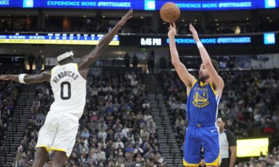 Golden State Warriors guard Klay Thompson (11) shoots a 3-point basket against Utah Jazz forward Taylor Hendricks (0) during the second half of an NBA basketball game Thursday, Feb. 15, 2024, in Salt Lake City. (AP Photo/Rick Bowmer)