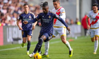 Real Madrid's Eduardo Camavinga, centre, challenges for the ball with Rayo's Oscar Trejo during the Spanish La Liga soccer match between Rayo Vallecano and Real Madrid at the Vallecas stadium in Madrid, Spain, Sunday, Feb. 18, 2024. (AP Photo/Manu Fernandez)