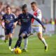 Real Madrid's Eduardo Camavinga, centre, challenges for the ball with Rayo's Oscar Trejo during the Spanish La Liga soccer match between Rayo Vallecano and Real Madrid at the Vallecas stadium in Madrid, Spain, Sunday, Feb. 18, 2024. (AP Photo/Manu Fernandez)