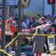 A woman is taken to an ambulance after an incident following the Kansa City Chiefs NFL football Super Bowl celebration in Kansas City, Mo., Wednesday, Feb. 14, 2024. The Chiefs defeated the San Francisco 49ers Sunday in the Super Bowl 58. (AP Photo/Reed Hoffmann)