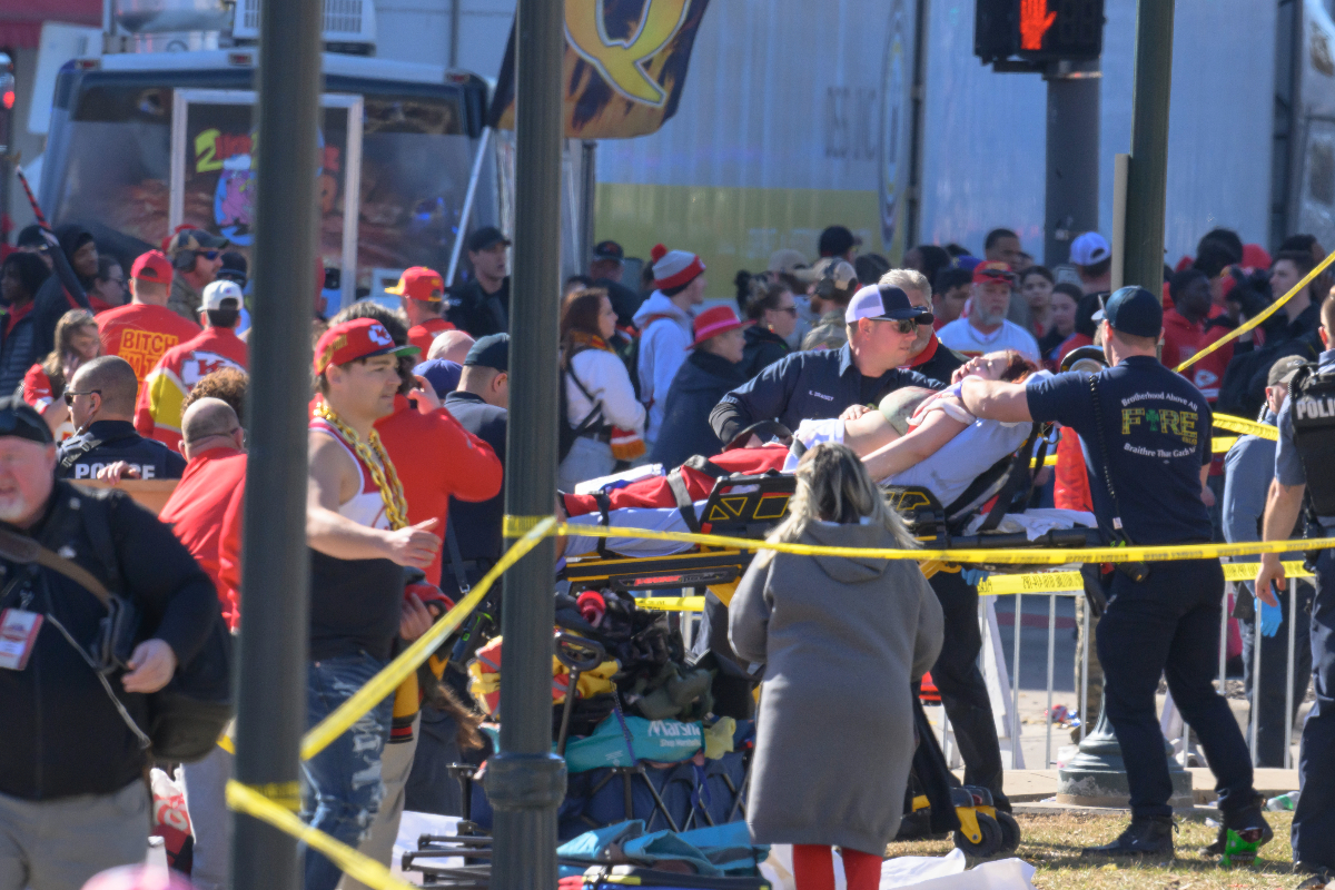 A woman is taken to an ambulance after an incident following the Kansa City Chiefs NFL football Super Bowl celebration in Kansas City, Mo., Wednesday, Feb. 14, 2024. The Chiefs defeated the San Francisco 49ers Sunday in the Super Bowl 58. (AP Photo/Reed Hoffmann)