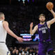 Sacramento Kings forward Domantas Sabonis (10) passes the ball as Denver Nuggets center Nikola Jokic (15) defends during the second half of an NBA basketball game in Sacramento, Calif, Friday, Feb. 9, 2024. (AP Photo/Jed Jacobsohn)
