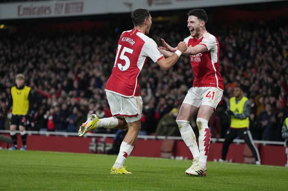 Arsenal's Jakub Kiwior, left, celebrates with Declan Rice after scoring his side's fourth goal during the English Premier League soccer match between Arsenal and Newcastle United at the Emirates stadium in London, England, Saturday, Feb. 24, 2024. (AP Photo/Alastair Grant)