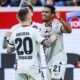Leverkusen's Amine Adli, right, celebrates after scoring his side's second goal during the Bundesliga soccer match between 1. FC Heidenheim and Bayer 04 Leverkusen in Heidenheim, Germany, Saturday, Feb. 17, 2024. (Tom Weller/dpa via AP)