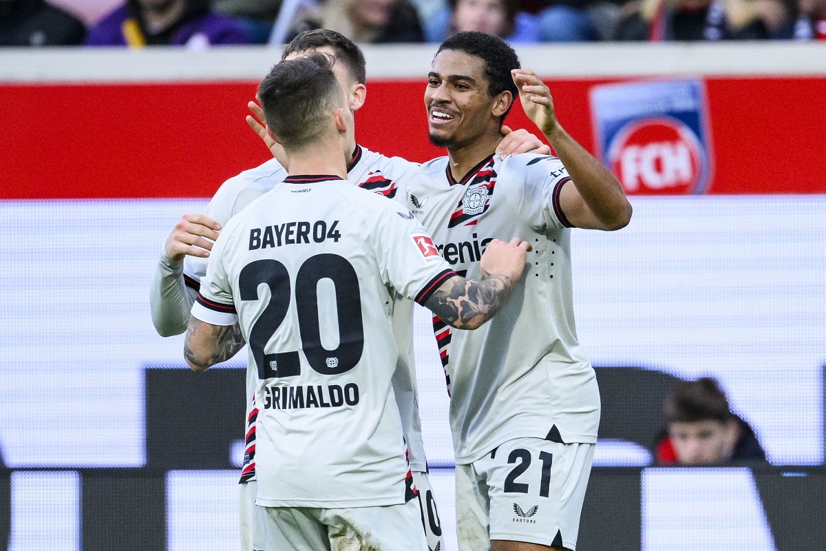 Leverkusen's Amine Adli, right, celebrates after scoring his side's second goal during the Bundesliga soccer match between 1. FC Heidenheim and Bayer 04 Leverkusen in Heidenheim, Germany, Saturday, Feb. 17, 2024. (Tom Weller/dpa via AP)