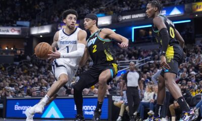 Memphis Grizzlies guard Scotty Pippen Jr. (1) drives on Indiana Pacers guard Andrew Nembhard (2) during the second half of an NBA basketball game in Indianapolis, Sunday, Jan. 28, 2024. The Pacers defeated the Grizzlies 116-110. (AP Photo/Michael Conroy)