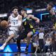 Memphis Grizzlies guard Scotty Pippen Jr. (1) drives on Indiana Pacers guard Andrew Nembhard (2) during the second half of an NBA basketball game in Indianapolis, Sunday, Jan. 28, 2024. The Pacers defeated the Grizzlies 116-110. (AP Photo/Michael Conroy)