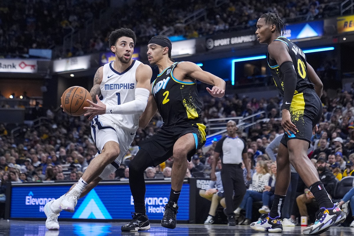 Memphis Grizzlies guard Scotty Pippen Jr. (1) drives on Indiana Pacers guard Andrew Nembhard (2) during the second half of an NBA basketball game in Indianapolis, Sunday, Jan. 28, 2024. The Pacers defeated the Grizzlies 116-110. (AP Photo/Michael Conroy)