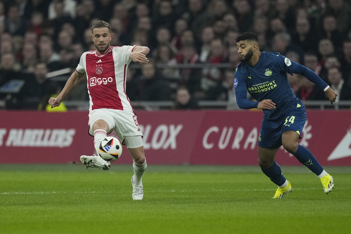 Ajax's Jordan Henderson, left, and PSV's Ismael Saibari, right, vie for the ball during the Dutch Eredivisie soccer match between Ajax and PSV at ArenA stadium Amsterdam, Netherlands, Saturday, Feb. 3, 2024. (AP Photo/Peter Dejong)