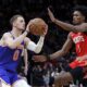 New York Knicks guard Donte DiVincenzo (0) looks to shoot while under pressure from Houston Rockets forward Amen Thompson (1) during the first half of an NBA basketball game Monday, Feb. 12, 2024, in Houston. (AP Photo/Michael Wyke)