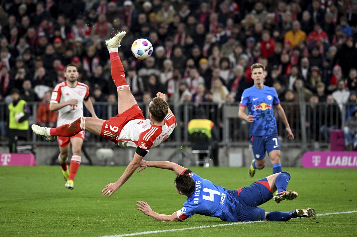 Bayern Munich's Harry Kane takes a back kick against Leipzig's Willi Orban during the Bundesliga soccer match between Bayern Munich and RB Leipzig, at the Allianz Arena in Munich, Germany, Saturday Feb. 24, 2024. (Sven Hoppe/dpa via AP)