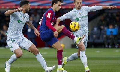 Barcelona's Joao Felix, center, duels for the ball with Getafe's Omar Alderete, left, and Getafe's Nemanja Maksimovic during a Spanish La Liga soccer match between Barcelona and Getafe at the Olimpic Lluis Companys stadium in Barcelona, Spain, Saturday, Feb. 24, 2024. (AP Photo/Joan Monfort)