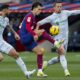 Barcelona's Joao Felix, center, duels for the ball with Getafe's Omar Alderete, left, and Getafe's Nemanja Maksimovic during a Spanish La Liga soccer match between Barcelona and Getafe at the Olimpic Lluis Companys stadium in Barcelona, Spain, Saturday, Feb. 24, 2024. (AP Photo/Joan Monfort)