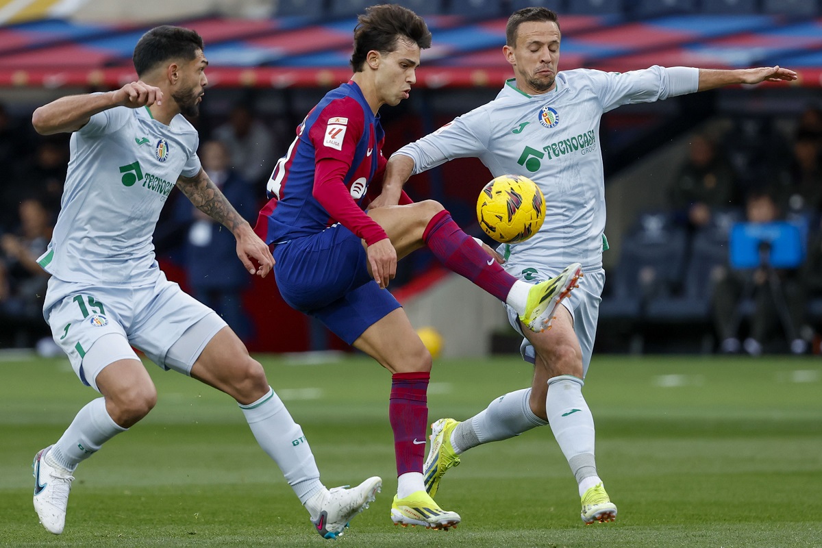 Barcelona's Joao Felix, center, duels for the ball with Getafe's Omar Alderete, left, and Getafe's Nemanja Maksimovic during a Spanish La Liga soccer match between Barcelona and Getafe at the Olimpic Lluis Companys stadium in Barcelona, Spain, Saturday, Feb. 24, 2024. (AP Photo/Joan Monfort)