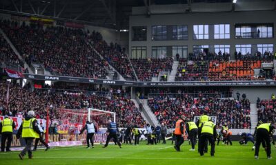 Members of the security staff pick up candy egs during a fan protest during the Bundesliga soccer match between SC Freiburg and Eintracht Frankfurt in Freiburgm Germany, Sunday, Feb. 18, 2024. (Tom Weller/dpa via AP)