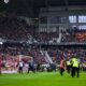 Members of the security staff pick up candy egs during a fan protest during the Bundesliga soccer match between SC Freiburg and Eintracht Frankfurt in Freiburgm Germany, Sunday, Feb. 18, 2024. (Tom Weller/dpa via AP)