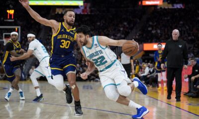 Charlotte Hornets guard Vasilije Micic (22) tries to get around Golden State Warriors guard Stephen Curry (30) during the second half of an NBA basketball game, Friday, Feb. 23, 2024, in San Francisco. (AP Photo/Godofredo A. Vásquez)
