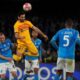 Barcelona's Ilkay Gundogan heads the ball besides Napoli's Mario Rui during the Champions League, round of 16, first leg soccer match between SSC Napoli and FC Barcelona at the Diego Maradona stadium in Naples, Italy, Wednesday, Feb. 21, 2024. (AP Photo/Gregorio Borgia)