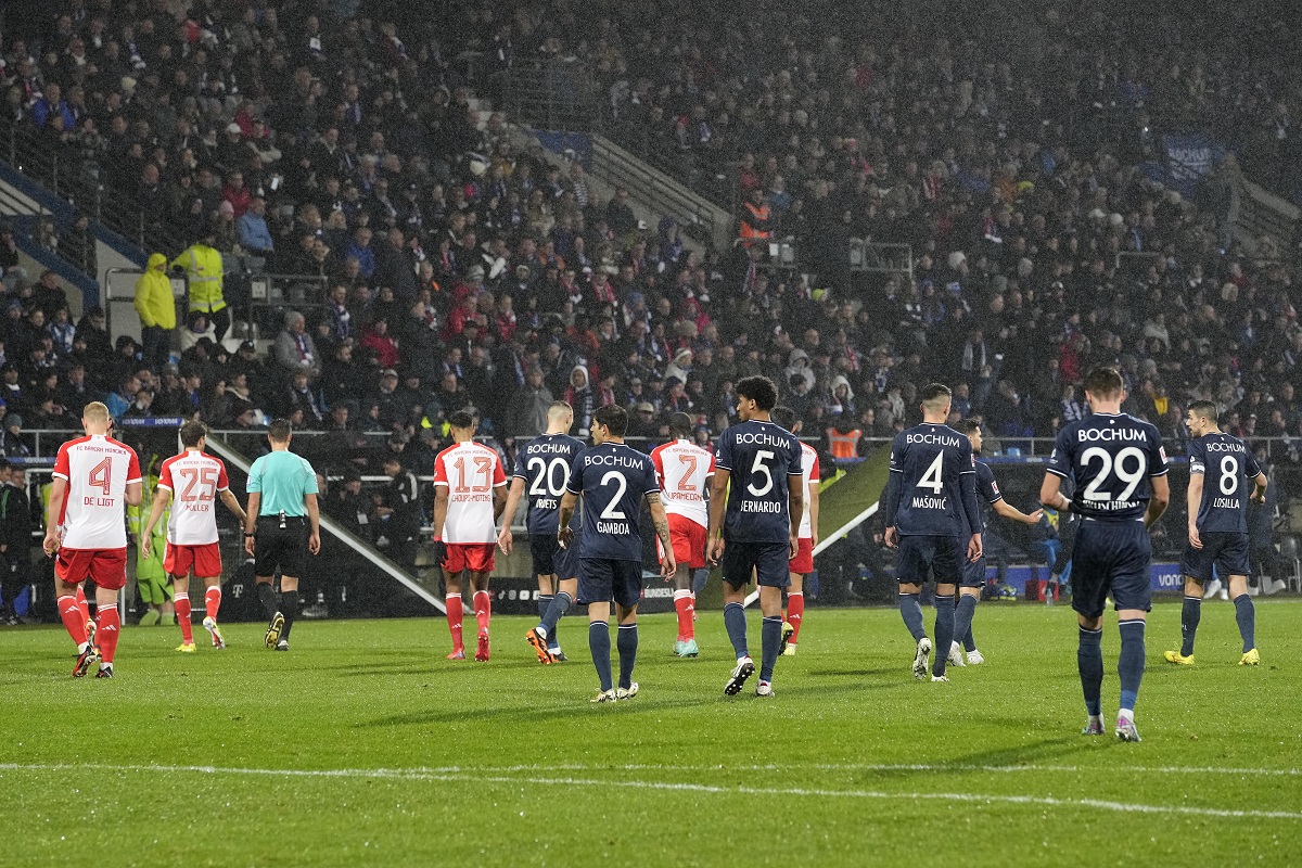 Both teams leave the pitch when the referee interrupted the match because of tennis balls on the pitch, thrown by fans as a protest against investors in the Bundesliga during the German Bundesliga soccer match between VfL Bochum and FC Bayern Munich in Bochum, Germany, Sunday, Feb. 18, 2024. (AP Photo/Martin Meissner)