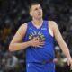 Denver Nuggets center Nikola Jokic walks across the court during the first half of an NBA basketball game against the Minnesota Timberwolves, Tuesday, March 19, 2024, in Minneapolis. (AP Photo/Abbie Parr)