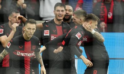 Leverkusen's Patrik Schick, center, celebrates after scoring the decisive goal during the German Bundesliga soccer match between Bayer Leverkusen and TSG Hoffenheim at the BayArena in Leverkusen, Germany, Saturday, March 30, 2024. (AP Photo/Martin Meissner)